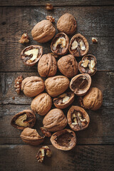 Broken walnuts flat lay on a rustic wooden table