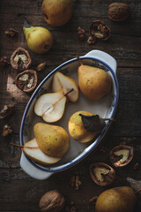 Organic pears and walnuts on a rustic table, flat lay style