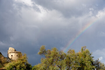 Rainbow and ancient fortified tower