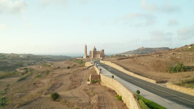 Beautiful Brown and Beige Colored Church Mediterranean Countryside on Malta Island, Aerial Establishing Shot forward Dolly