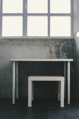 Minimalist industrial interior concept with white wooden desk set and  grunge concrete walls with white square windows for lighting