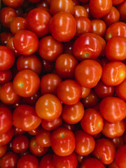 Bright red fresh tomatoes. Tomatoes in the hypermarket. Vertical image.