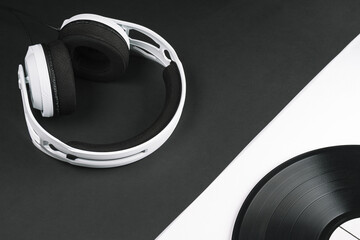 DJ composition of headphones and vinyl records on a black and white background