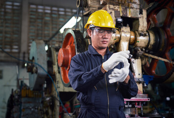 Asian engineer is wearing working groves before working in industry