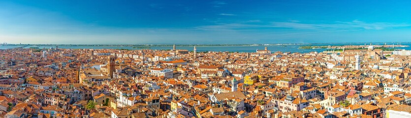 Aerial panoramic view of Venice city old historical city centre, buildings with red tiled roofs, San Giuliano Mestre and blue sky background, Veneto Region, Northern Italy. Amazing Venice cityscape.