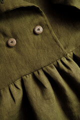 Fragment of an olive colored linen dress