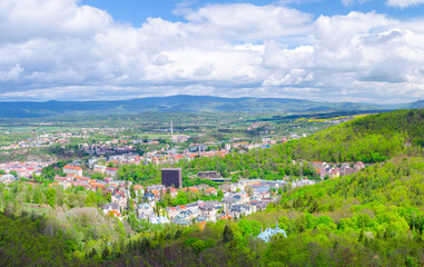 Karlovy Vary city aerial panoramic view with row of colorful multicolored buildings and spa hotels in historical city centre. Panorama of Karlsbad town and Ore mountain range, Czech Republic