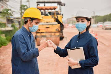 Engineer wear face mask shake hand no touch on site construction