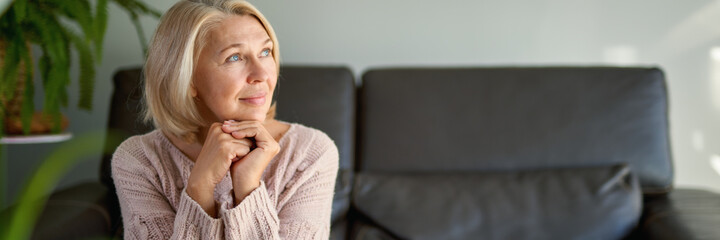 Happy Senior Woman Sitting on Sofa