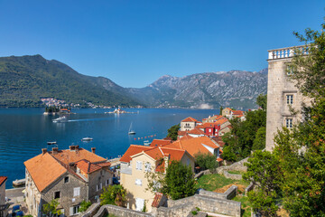 Naklejka na ściany i meble Top view of the houses and streets of the old coastal town of Perast, located in the Bay of Kotor, Montenegro.