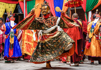 Bhutan,  in the village of Bumthang, a monk mask dancer in his colourful costume dances at the festival of Jakar.