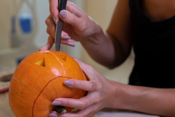 the process of making a Halloween pumpkin. cutting out the mouth. horror theme and Hallowe'en. 