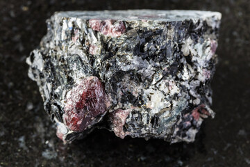 macro photography of sample of natural mineral from geological collection - raw Garnet crystals in...