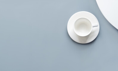 Fototapeta na wymiar Empty white cup on blue and white background. Flat lay, top view, overhead. Mock up for drink. Minimalism.