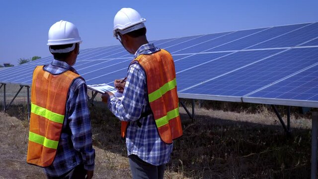 Electrical, instrument technician and worker discuss while working for maintenance electrical system at solar panel field