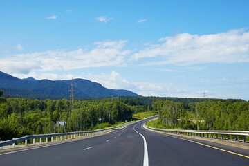 Beautiful asphalt roadway to lake Baikal on a sunny summer day, Russia.