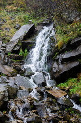 Waterfall in autumn forest. Carpathian Mountains, Ukraine.