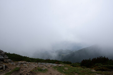 Autumn landscape in the mountains with a fog. Carpathian Mountains, Ukraine.