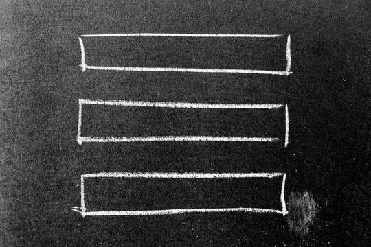 White chalk hand drawing in square or banner shape on black board background