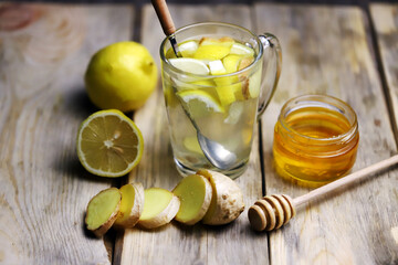 Ginger lemon drink in a glass mug. A healthy hot drink for colds and viruses. Home remedies for colds