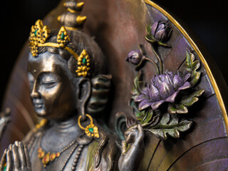 Hand of Avalokiteshvara holding purple lotus