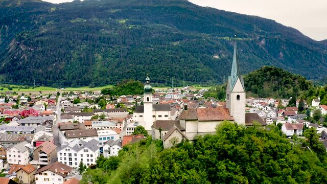 Aerial view of the Church of St. John the Baptist and the Dormition Church in Domat, the Canton of Grisons in Switzerland