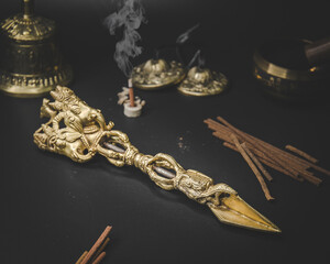 Tibetan ritual phurba on dark surface