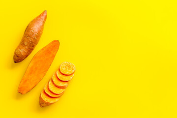 Layout of sweet potatoes. Organic vegetables background, overhead view