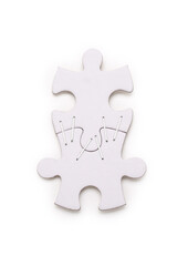 Two blank jigsaw puzzle pieces stapled together on a white background. Contains clipping path.