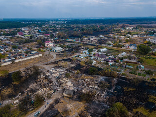 Fototapeta na wymiar Destroyed houses after the fire in Ukraine. Aerial photo