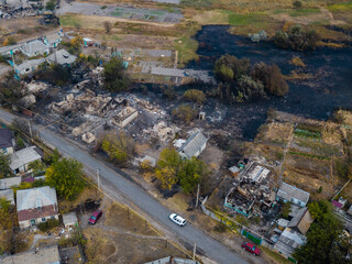 Destroyed houses after the fire in Ukraine. Aerial photo