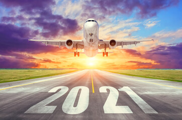 The inscription on the runway 2021 surface of the airport runway with take off airplane. Concept of...