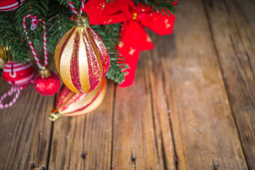 Christmas holiday background. Decorated christmas tree with traditional ball and toys, gift boxes over wooden background copy space