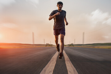 The man with runner on the street be running for exercise.