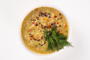 Cream soup with spices in white bowl on white background. Vegetarian, vegan concept
