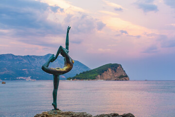 BUDVA, Montenegro - Aug 07 2016 Statue of a ballerina Dancer of Budva in sunset near Mogren beach, Budva, Montenegro. The statue is a symbol of the city