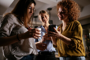 Colleagues in office talking and having fun. Friends working together.