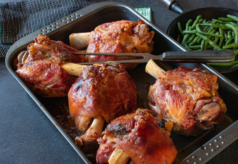 grilled Knuckles of pork on a baking tray