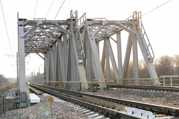 metal railway bridge over a small river, selective focus, tinted image