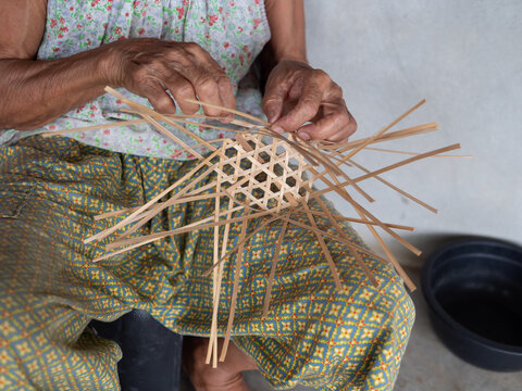 Bamboo basket weaving by old woman hands, handmade and rural people lifestyle.
