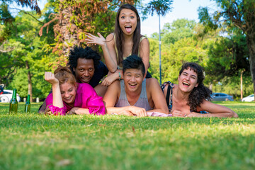 A happy group of friends laying together in the garden