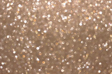 An abstract silver background with sparkle lights and bokeh.