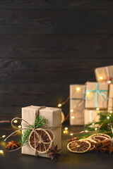 Christmas zero waste concept. Eco friendly packaging gifts in kraft paper on a dark wooden table. DIY gifts, eco decor. Copy space