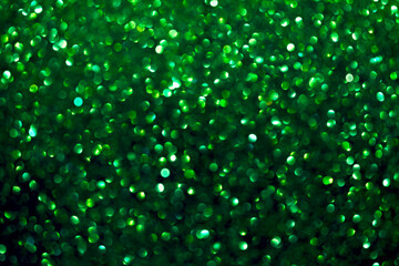 An abstract green background with sparkle lights and bokeh. Green blurred light.