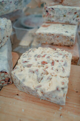 Different cheese in packs and in bulk on market counter