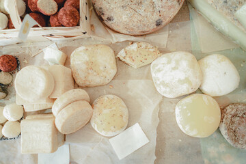 Different cheese in packs and in bulk on market counter