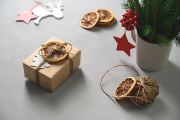 Christmas zero waste concept. Eco friendly packaging gift in kraft paper on a gray table. DIY gift, eco decor.