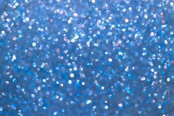 An abstract blue background with sparkle lights and bokeh.