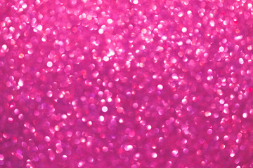 An abstract pink background with sparkle lights and bokeh. Pink blurred light.