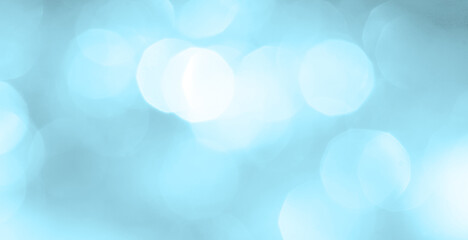 Obraz premium Bokeh light on blue background, sky with circle glitter light blue. Snow abstract soft glowing with vivid bright light and bokeh blur effect. 